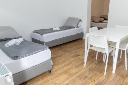 a room with two beds and a table and a desk at Z.Bilić V&V in Jesteburg