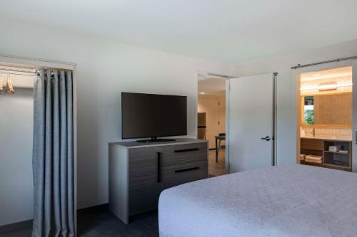 a bedroom with a bed and a flat screen tv at Home2 Suites By Hilton East Haven New Haven in East Haven