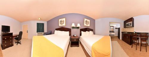 a hotel room with two beds and a desk at Five Star Inn Burleson in Burleson