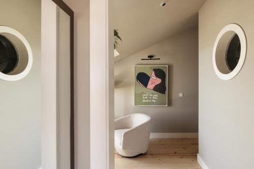 a hallway with a white chair in a room at Dare Lisbon River in Lisbon