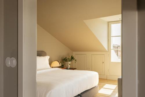 a bedroom with a white bed and a window at Dare Lisbon River in Lisbon