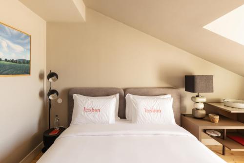a bedroom with a white bed with two white pillows at Dare Lisbon River in Lisbon