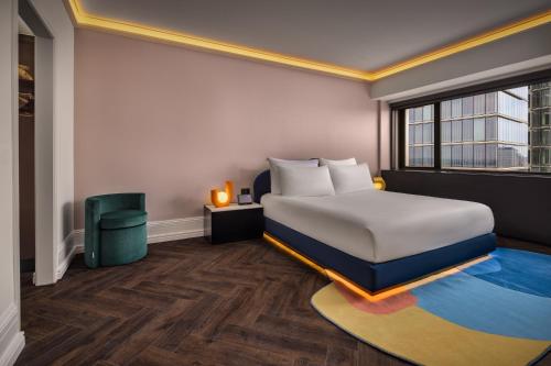 a hotel room with a bed and a window at Cardo Brussels, Autograph Collection in Brussels