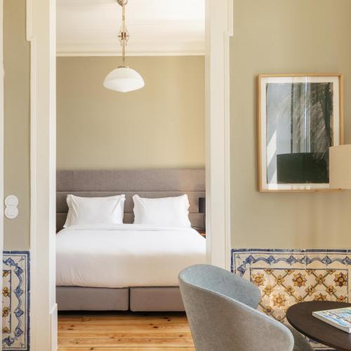a bedroom with a bed and a table and a chair at Dare Lisbon River in Lisbon