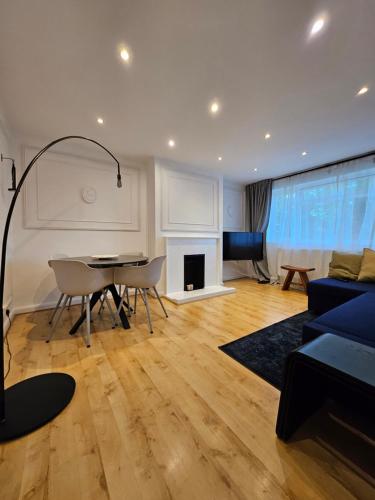 a living room with a couch and a table at Wembley, Cosy 2 Bed Apa, Next to the park in Harrow on the Hill