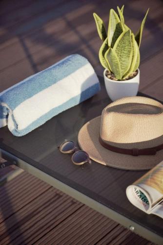 a table with a towel and a hat and sunglasses at Playa Terreros in San Juan de los Terreros