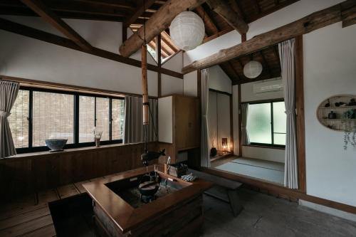 a bathroom with a sink and a large window at River & Forest Genpuan Sauna Drum bath BBQ Hearth in Shibukawa