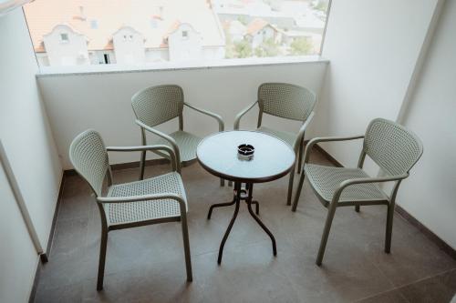 a group of chairs and a table on a balcony at TOP VIEW apartment 40 in Arandjelovac