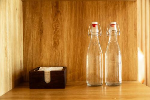two bottles of water sitting next to a wooden box at The Urban Quarter Hanoi in Hanoi