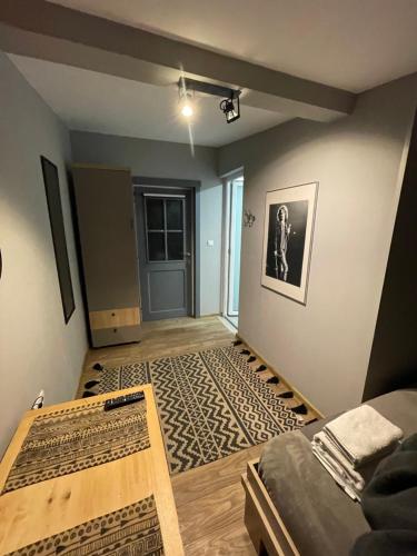 a living room with a bed and a rug at Robert Local Social Restaurant & Accomodation in Hîrşova