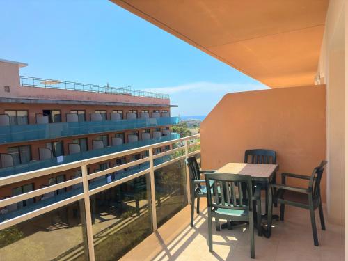 a balcony with a table and chairs on a building at Aparthotel SunClub Salou in Salou