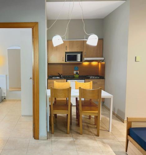 a kitchen and dining room with a table and chairs at Aparthotel SunClub Salou in Salou