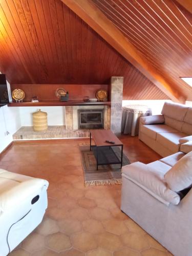 a living room with a couch and a fireplace at Pensión La Plaza in Betanzos