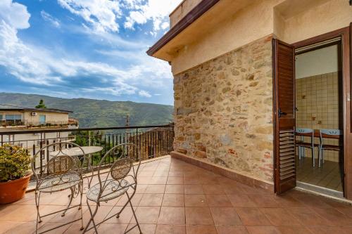 a balcony with chairs and a table and a view at Antica Dimora Marinelli in Ficarra