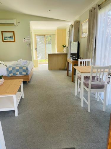 a living room with a bed and a table at Euroa Motor Inn in Euroa