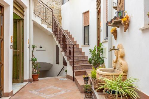 a staircase in a house with potted plants at Antica Dimora Marinelli in Ficarra