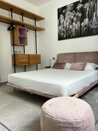 a bedroom with a large bed and a couch at Lisetta Gardens Boutique & Suites in Cisternino