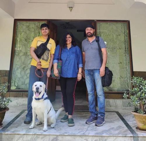 a group of people standing in front of a door with a dog at Ronglyang Lotus Villa in Tādong