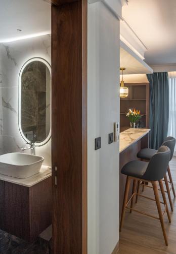 a bathroom with a sink and a mirror at Okash City Boutique Hotel in Nairobi