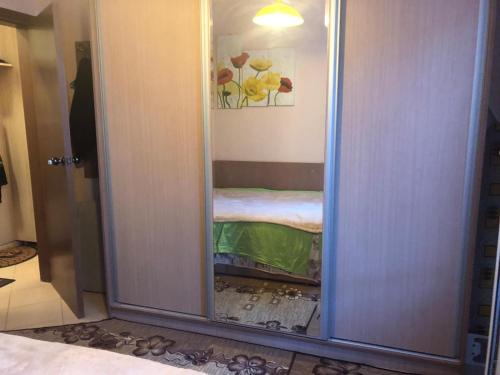 a door with a mirror in a room at Tanjas City Apartment in Varna City
