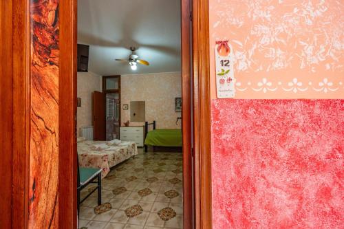 a door leading to a room with a bedroom at Antica Dimora Marinelli in Ficarra