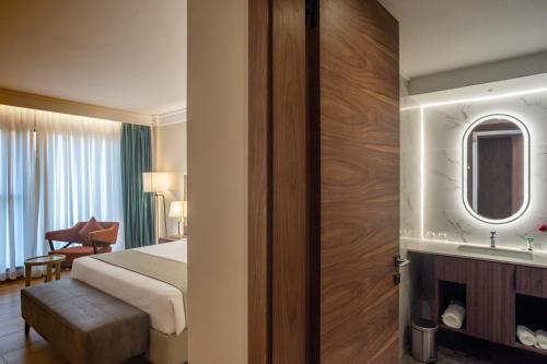 a hotel room with a bed and a bathroom at Okash City Boutique Hotel in Nairobi