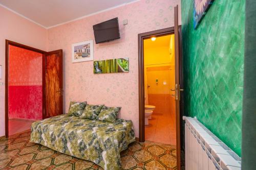 a bedroom with a bed and a bathroom at Antica Dimora Marinelli in Ficarra