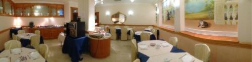 a dining room with a table and chairs in it at Hotel Minerva in Pordenone