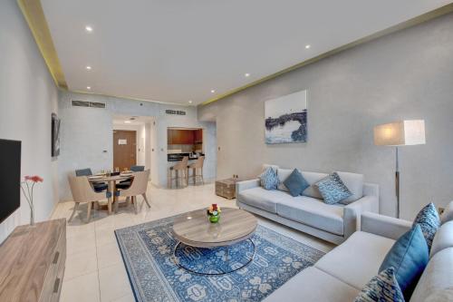 a living room with a couch and a table at SUHA Creek, Waterfront al Jaddaf in Dubai
