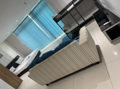 a living room with a swimming pool and a couch at JB City D'Esplanade Shopping mall apartment in Johor Bahru