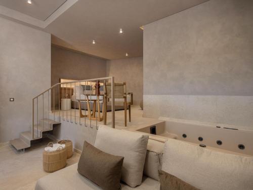 a living room with a couch and a bed at Hestia Boutique Rooms in Nea Kydonia