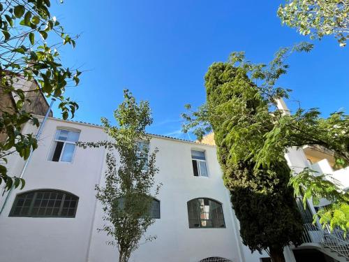 a white building with trees in front of it at Hotelito Boutique Badalona Gran Villa in Badalona
