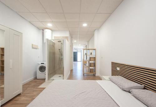 a bedroom with a bed and a walk in shower at RentalSevilla Bellavista - La Palmera in Seville