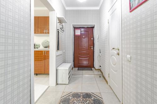 a hallway with a red door in a house at Уютная квартира рядом с Батырмол и Баянтау in Pavlodar
