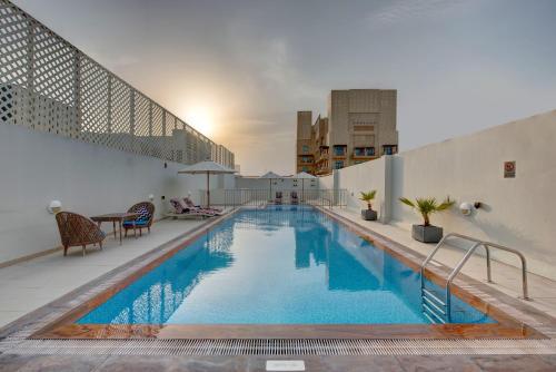 a swimming pool on the roof of a building at SUHA Creek, Waterfront al Jaddaf in Dubai