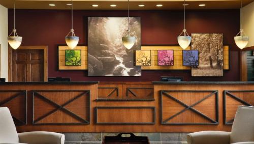 a bar in a hotel lobby with paintings on the wall at Marriott Willow Ridge 2BD sleeps 8 in Branson