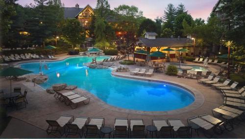 a large swimming pool with lounge chairs and tables at Marriott Willow Ridge 2BD sleeps 8 in Branson