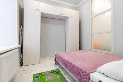 a bedroom with a bed and a large sliding door at Трех комнатные апартаменты в новом доме рядом с Батырмол in Pavlodar
