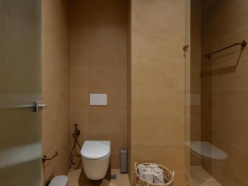 a bathroom with a toilet and a shower at Hestia Boutique - Renovated Rooms Just Steps from the Beach in Agia Marina Nea Kydonias