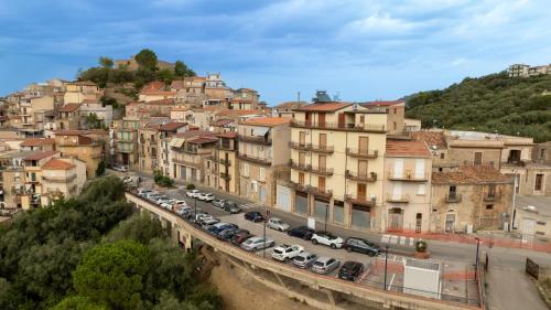 a city with cars parked in a parking lot at Antica Dimora Marinelli in Ficarra