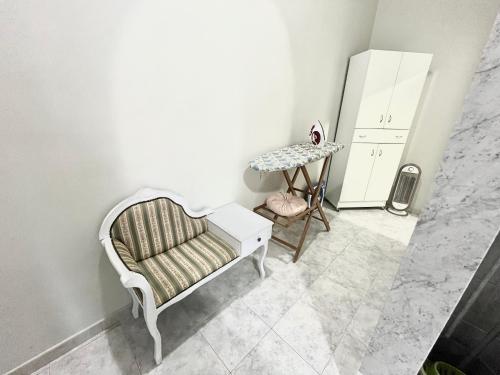 a living room with a chair and a table at L’angolo rosa in Carosino