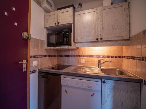une cuisine avec un évier et un micro-ondes dans l'établissement Studio coquet à 50m des pistes, proche commerces, balcon et casier à ski - FR-1-356-204, à Valmorel
