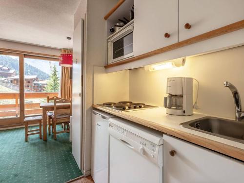 - une cuisine avec un évier et une table avec vue dans l'établissement Appartement confortable, pieds des pistes, balcon, casier à skis - FR-1-355-58, à Méribel