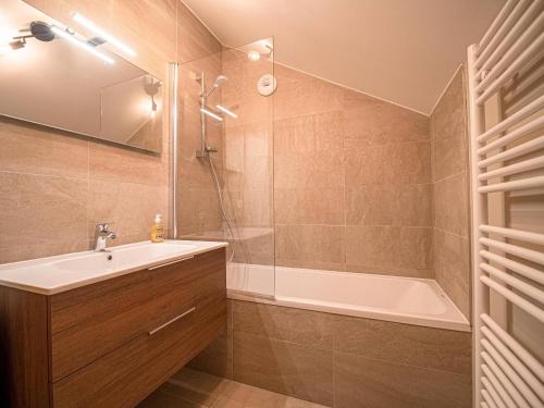 a bathroom with a shower and a sink and a tub at Chalet 3* Valmorel, skis aux pieds, 3 chambres, parking, WIFI - FR-1-356-401 in Valmorel