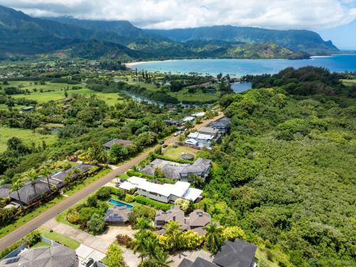 an aerial view of a house with a road and a lake at Hanalei Plantation home in Princeville