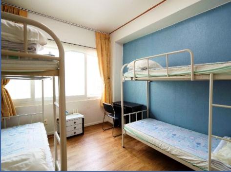 Postel nebo postele na pokoji v ubytování Hwaseong Guesthouse