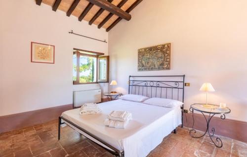 a bedroom with a bed and two tables at Cozy Home In Spoleto With Wifi in Spoleto
