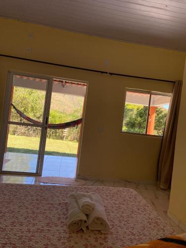 a bedroom with two windows and a bed in a room at Praia do Jatobá in Sao Jorge