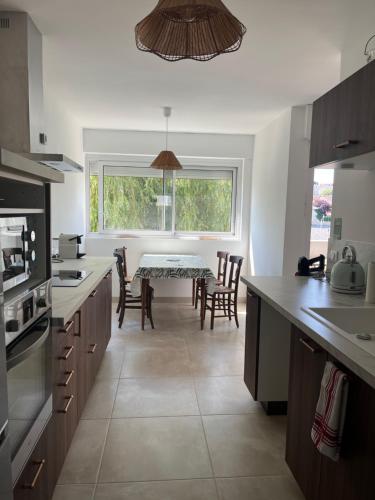 une cuisine avec une table et des chaises ainsi qu'une salle à manger dans l'établissement Balcon sur la rivière, à Périgueux