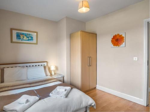 a bedroom with a bed and a cabinet at Inishnee Haven in Galway
